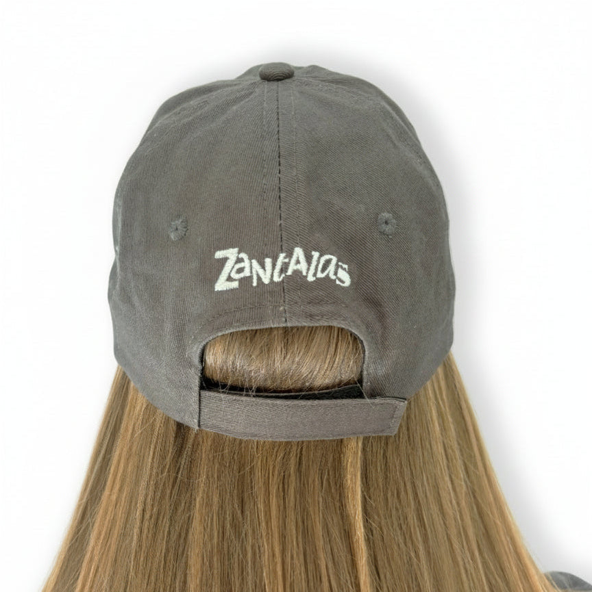 Rear view of the back of a women's Dad cap, she is wearing a grey Dad cap with equestrian branding