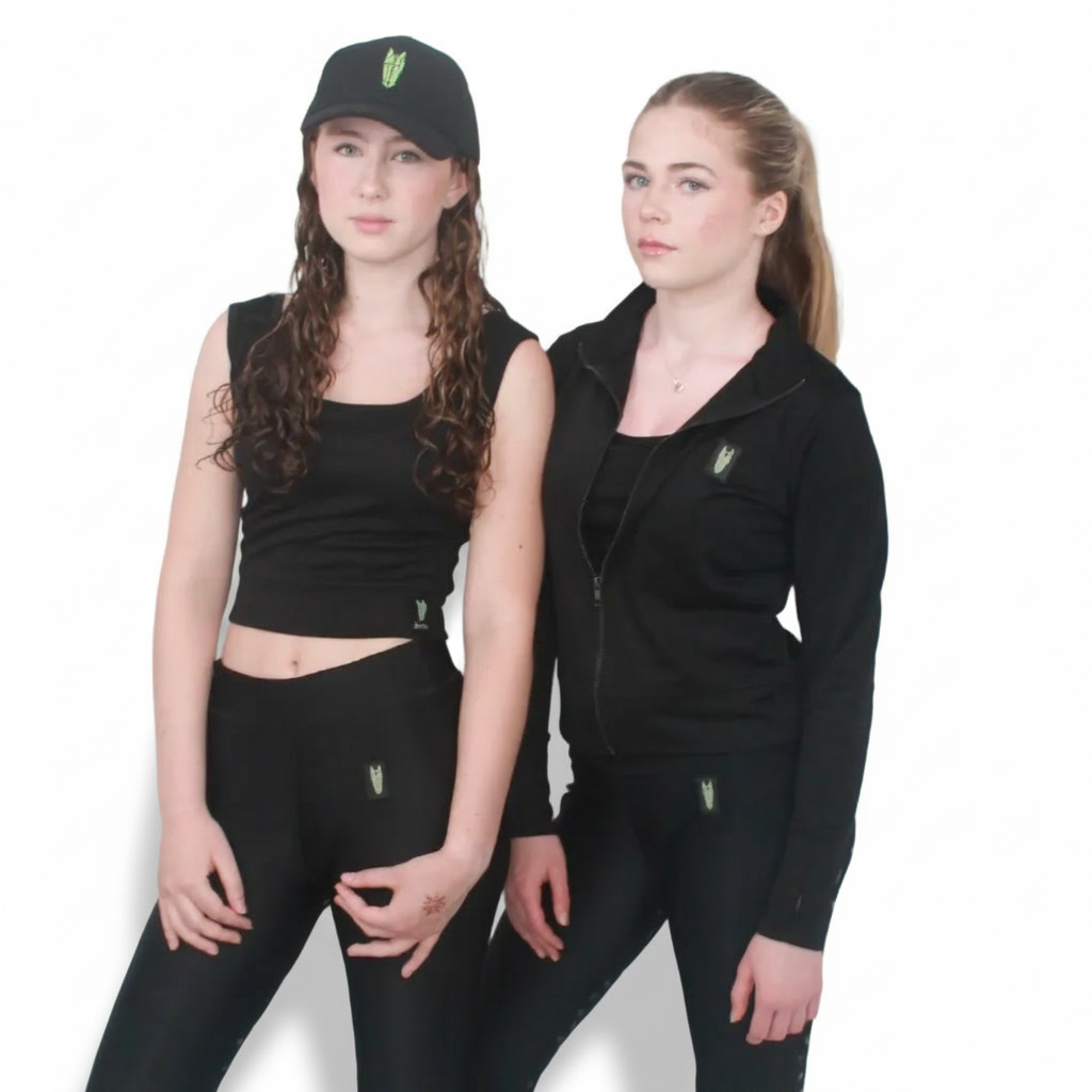 Two late teenage girls, one wearing a light equestrian cover up top/jacket in black with a striking horse head logo